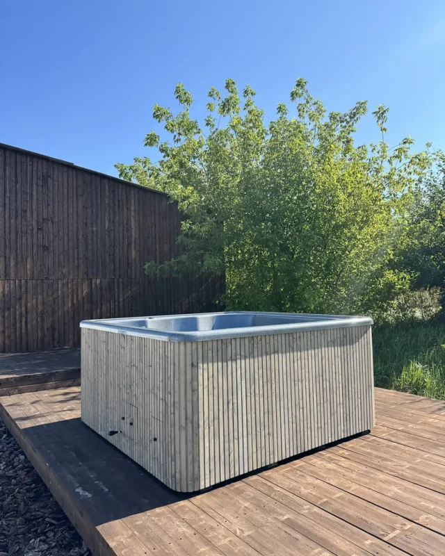 Modern outdoor electric hot tub with 3D Granite jacuzzi insert, perfect for relaxing on a wooden deck.
