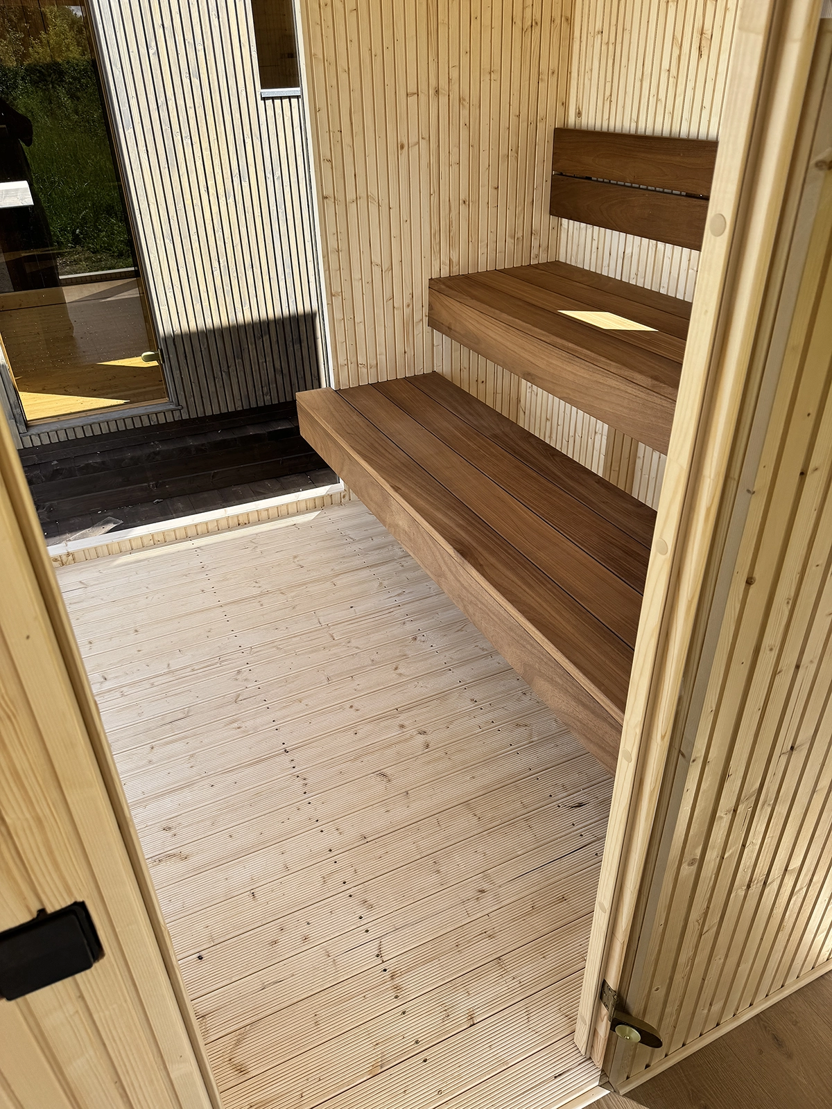 View from the Comfort M changing room into the sauna of TAVO Panoramic Sauna