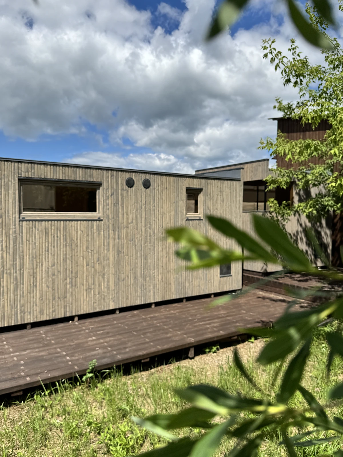Rear view of TAVO Panoramic Sauna with opening windows in the sauna and changing room