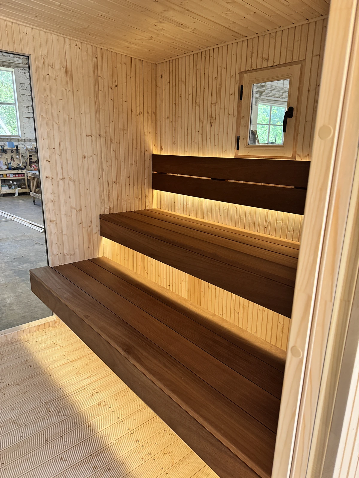 Ambient LED lighting under the floating Thermowood benches and backrests
