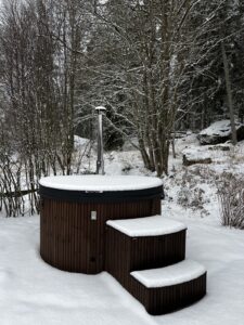 Covered hot tub with insulated lid in winter